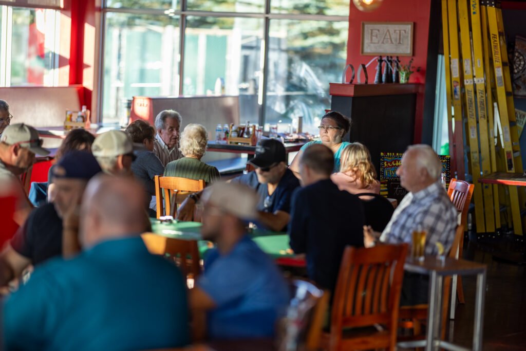 Guests seated around poker tables inside the pub