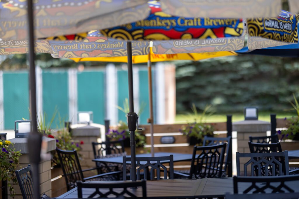 Empty patio tables and chairs under umbrellas