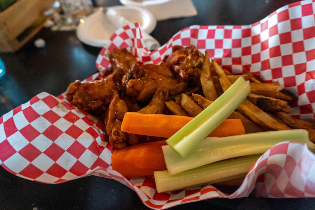 Wings and fries with carrot and celery sticks