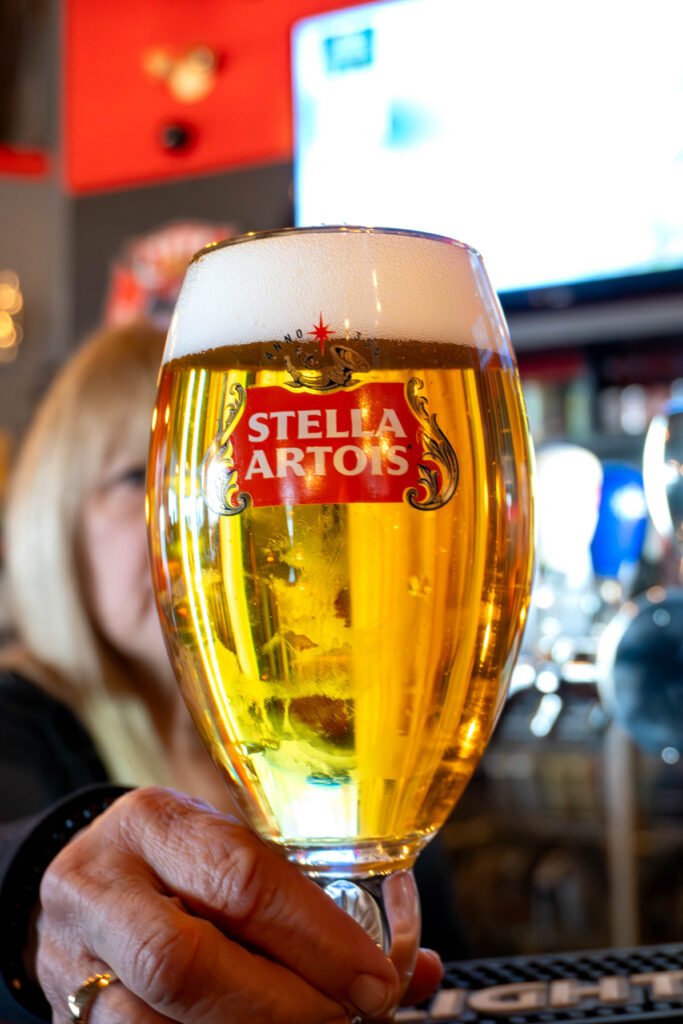 Hand holding a glass of draft beer